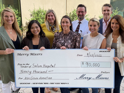 Merry Mixers bringing a donation check to Salem Hospital to support behavioral health